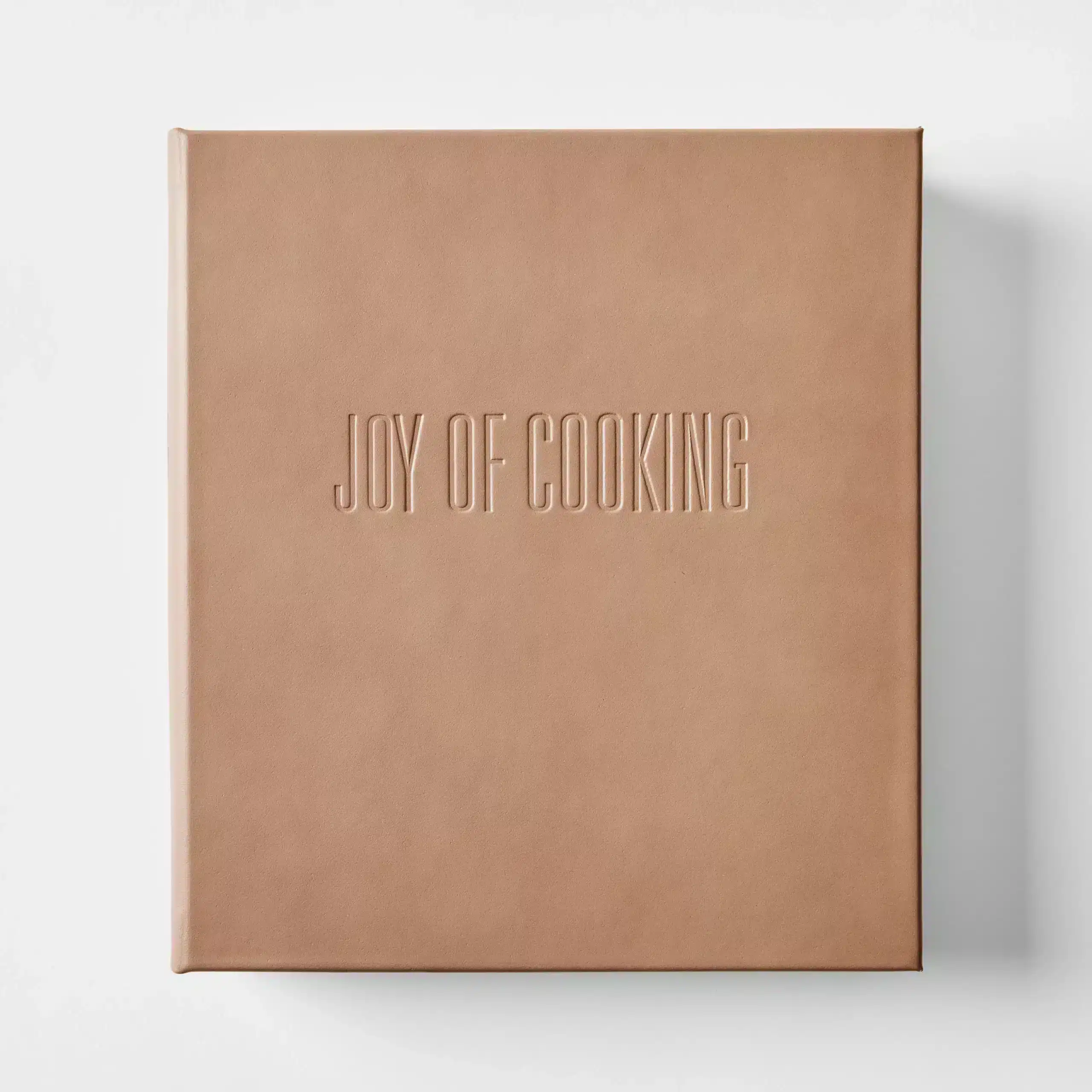 Leather-wrapped 'Joy of Cooking' book, featuring premium taupe genuine leather and an embossed hardcover, perfect for gifting to cooks