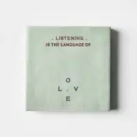 mint green napkin with the phrase- Listening is the Language of Love printed in a minimalist layout
